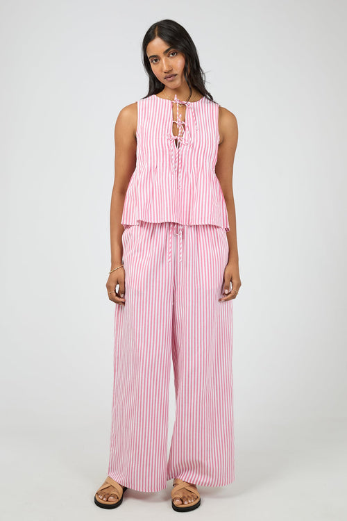 Woman wearing a pink and white striped outfit on a white background