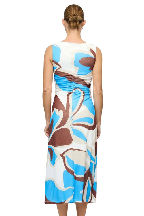 Woman wearing a sleeveless dress with a floral pattern on a white background