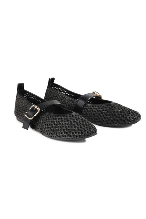 A pair of black pointed-toe flats with a textured, openwork mesh-like upper and a thin strap across the instep with a small gold-tone buckle, shown on a plain white background.