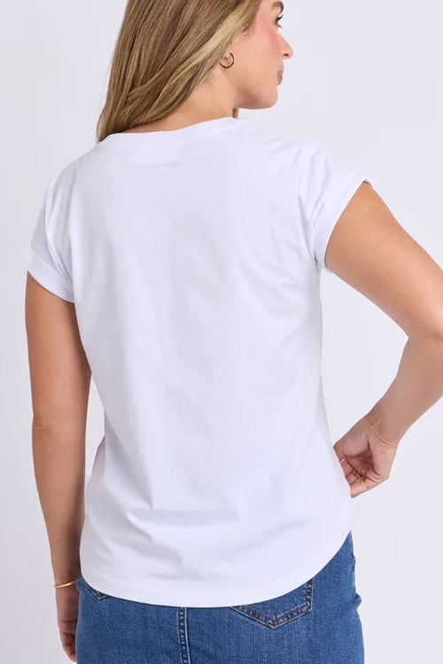 A woman shown from the back wearing a plain white short-sleeve t-shirt and blue jeans, standing against a light gray studio background.