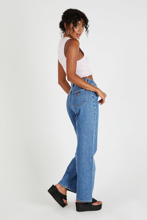 model wears blue straight leg jeans