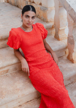 model wears a red puff sleeve midi dress