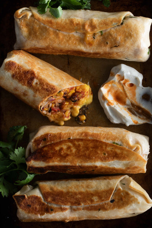 A two-column recipe spread for Cheesy Grilled Burritos. The left column contains the recipe text, ingredients list, and preparation instructions on a white page.