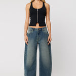 Woman wearing dark wash denim blue jeans with wide leg 