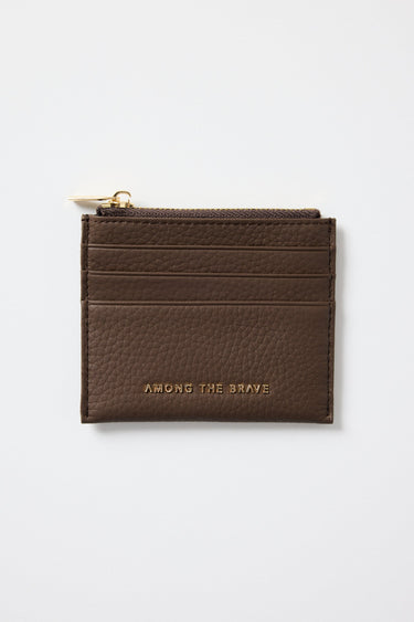 Brown leather cardholder with gold zipper on a white background