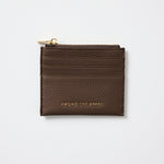 Brown leather cardholder with gold zipper on a white background