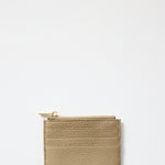 Beige cardholder with gold zipper on a light gray background