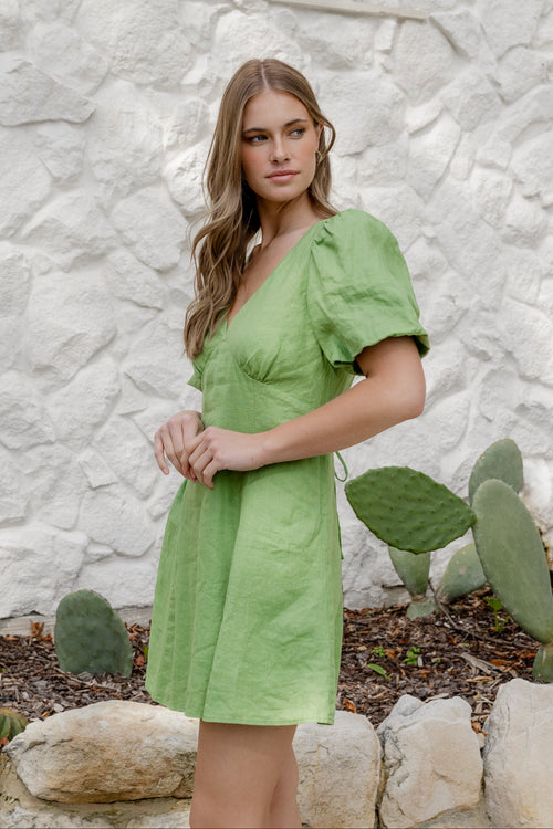 model wearing a green dress