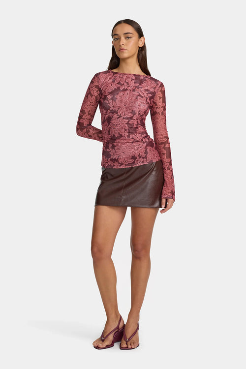 Model wears a mesh long sleeve paisley Burgundy top