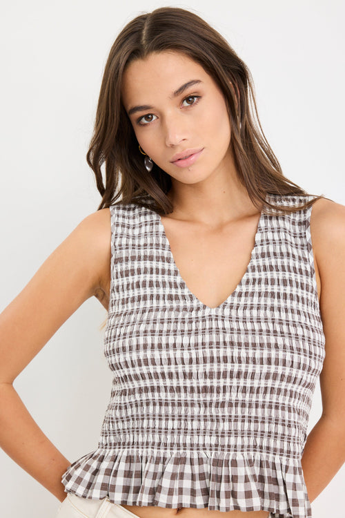 Chocolate gingham sleeveless shell top with frill hem, styled with cream jeans