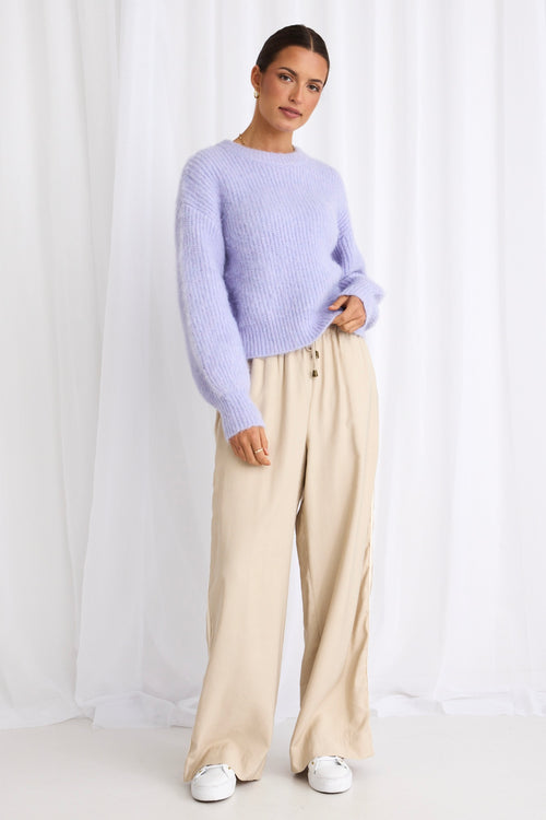 model wears a purple knit