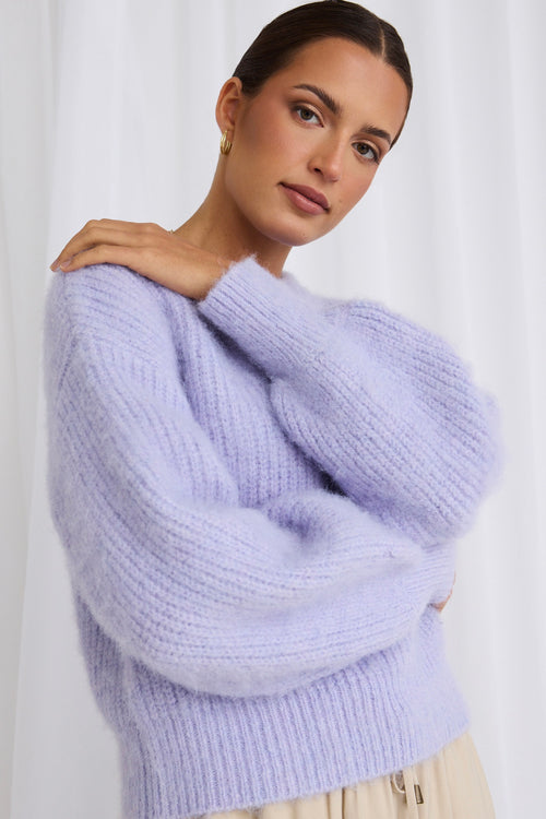 model wears a purple knit