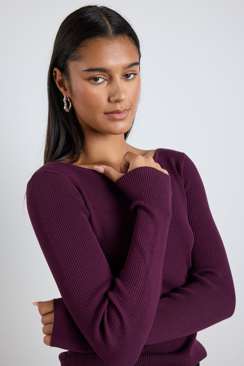 model wears burgundy red knit long sleeve top