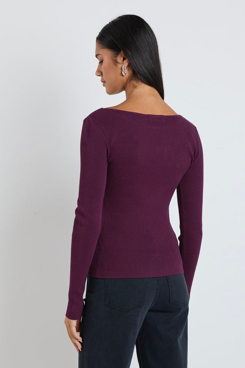 model wears burgundy red knit long sleeve top