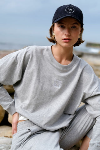 model wears a grey crew sweater