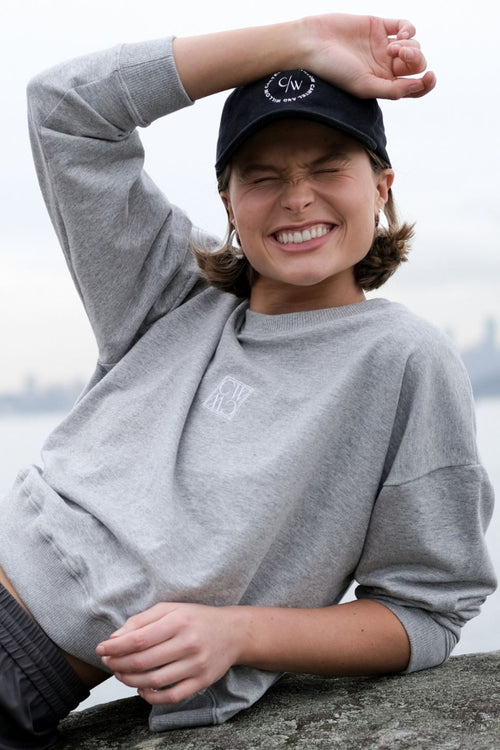 model wears a grey crew sweater