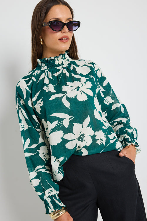 model wears green floral shirred top