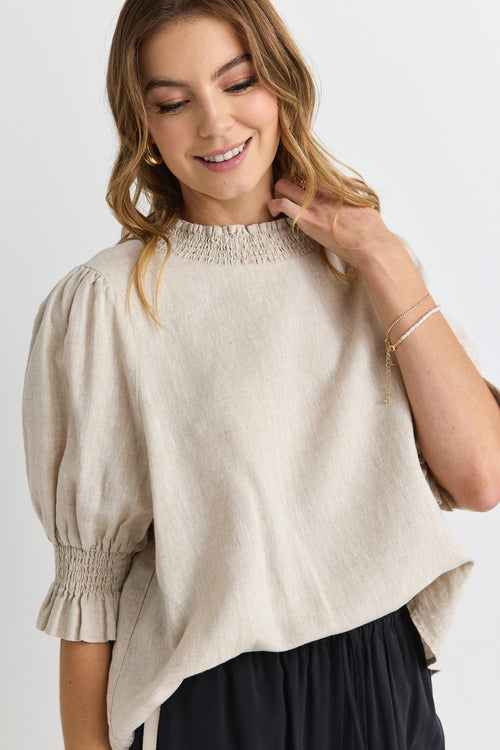 model wears a beige linen blouse