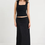 Model wearing a black lace skirt and black tank