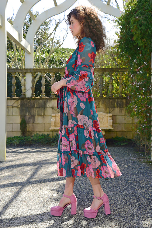 Model wears a green pink floral maxi dress