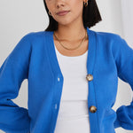 model wears a blue cardigan