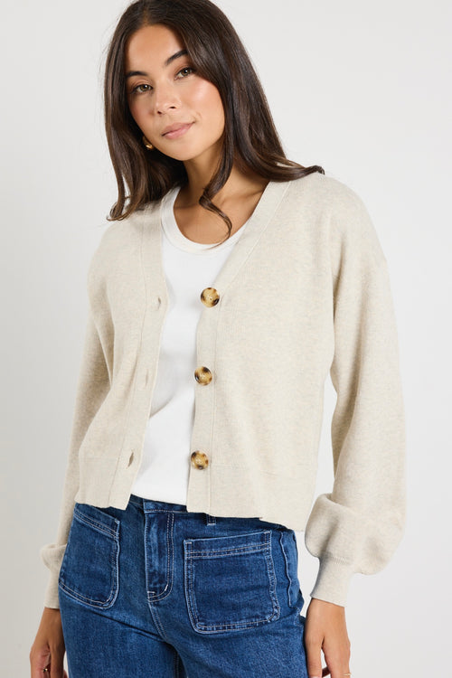 model wears a beige cardigan