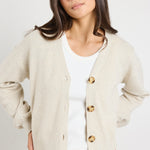 model wears a beige cardigan