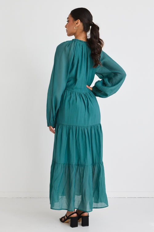 model wears a green maxi dress