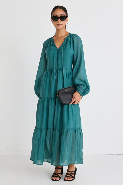 model wears a green maxi dress