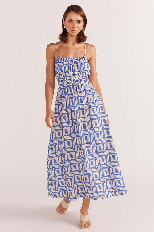 model wears a blue white print maxi dress