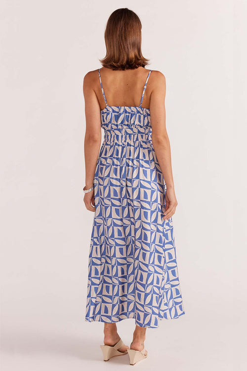 model wears a blue white print maxi dress