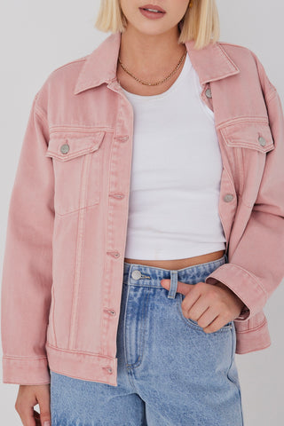 model wears pink denim jacket