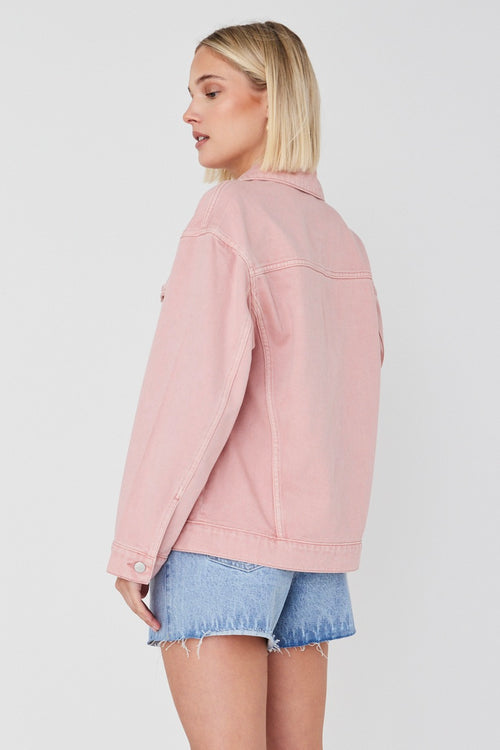 model wears pink denim jacket 