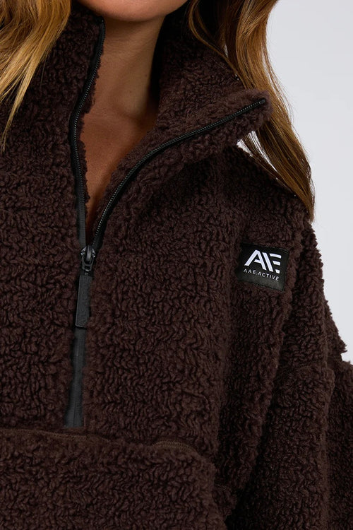 model is wearing a brown teddy sweatshirt