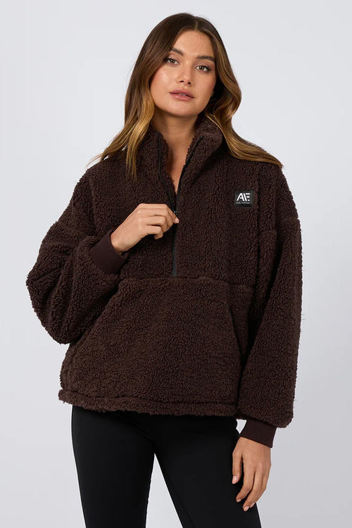 model is wearing a brown teddy sweatshirt