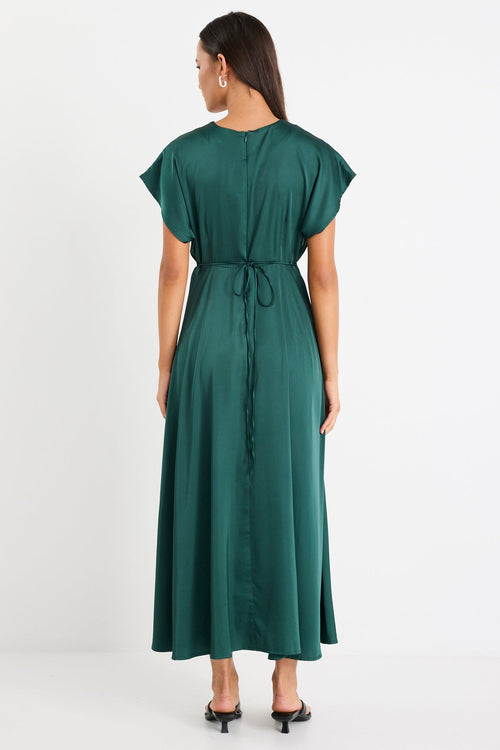 Woman wearing a satin green maxi dress