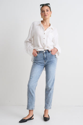 Model wears blue jeans with a white shirt 
