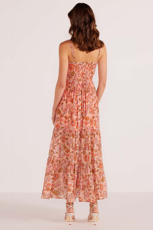 model wears a pink floral maxi dress