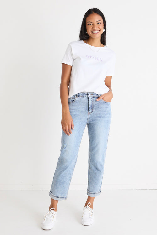 Model wears blue jeans with a white shirt 