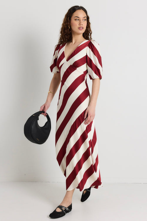 model wears a red and white stripe maxi dress