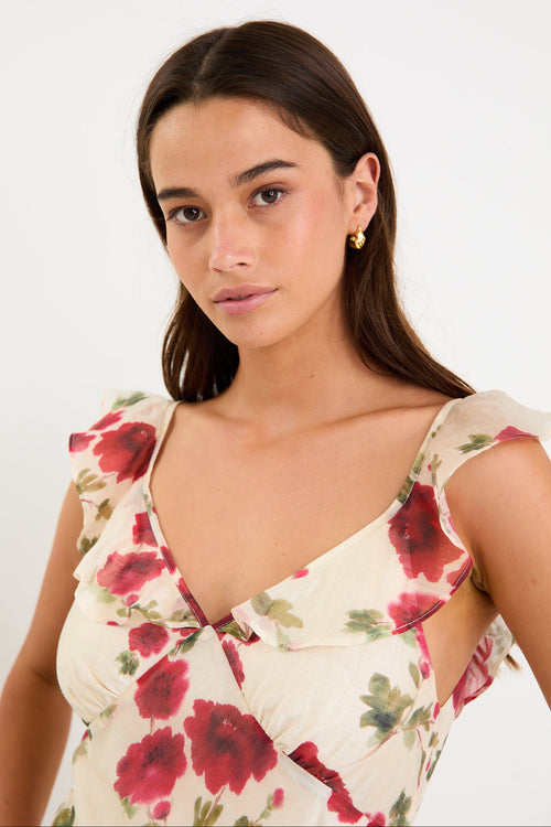 Woman wearing a floral white dress with frills