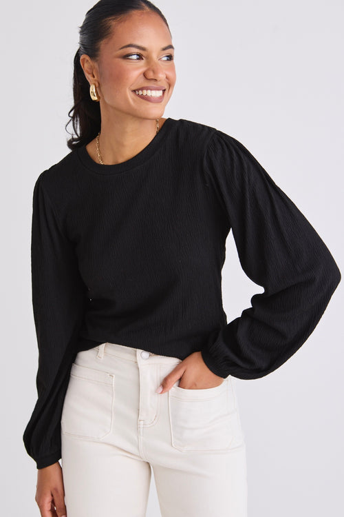 model wears a black long sleeve top