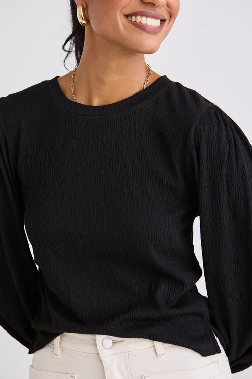 model wears a black long sleeve top