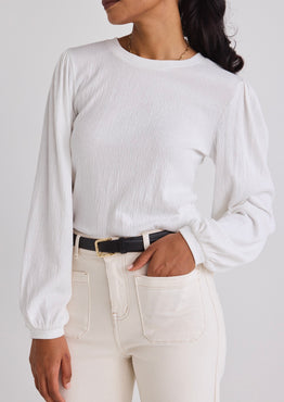 model wears a white long sleeve top