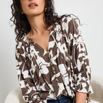 Mode wears a chocolate pattern print blouse top