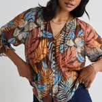 model wears a brown floral top