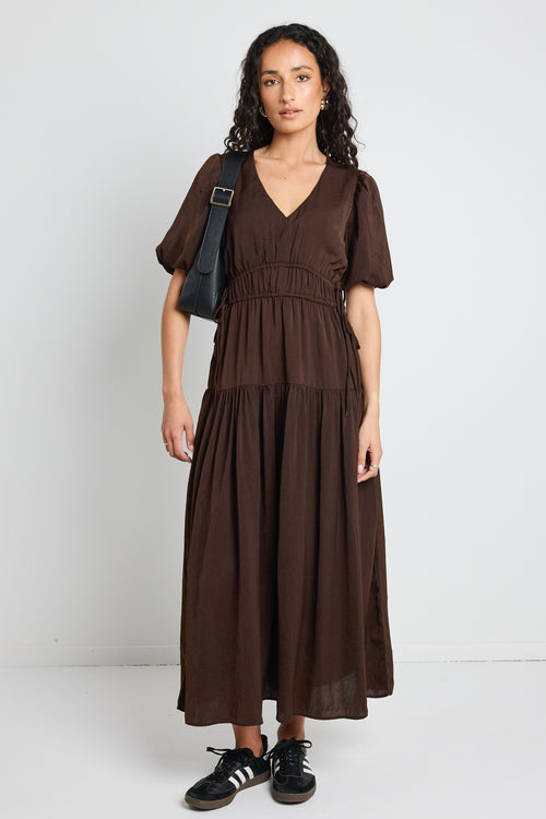 model wears brown satin maxi dress