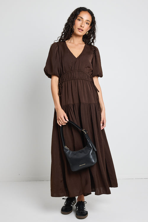 model wears brown satin maxi dress