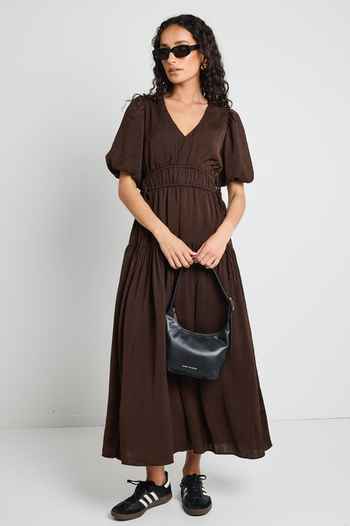 model wears brown satin maxi dress