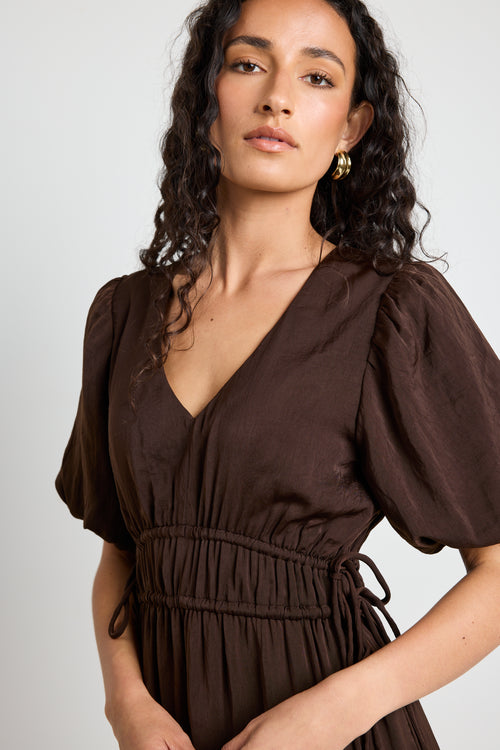 model wears brown satin maxi dress